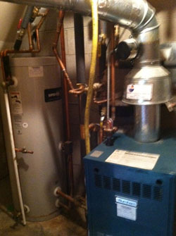 An indirect water heater: the blue boiler heats water in a pipe that runs in a coil through the storage tank for both space and domestic hot water heating.