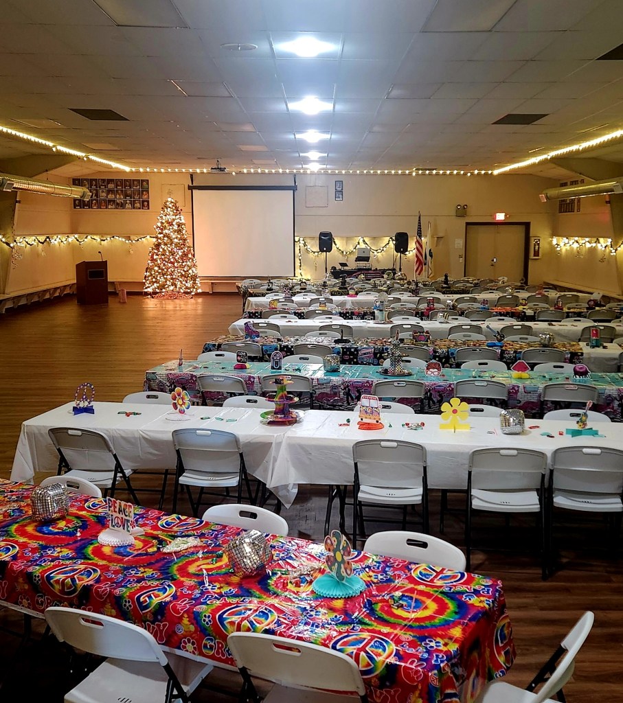 A room set up with tables and a projector screen