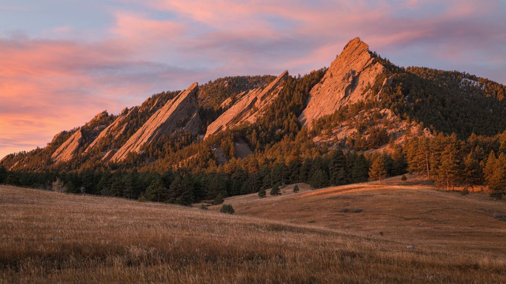 Boulder flatirons during sunset with pink clouds