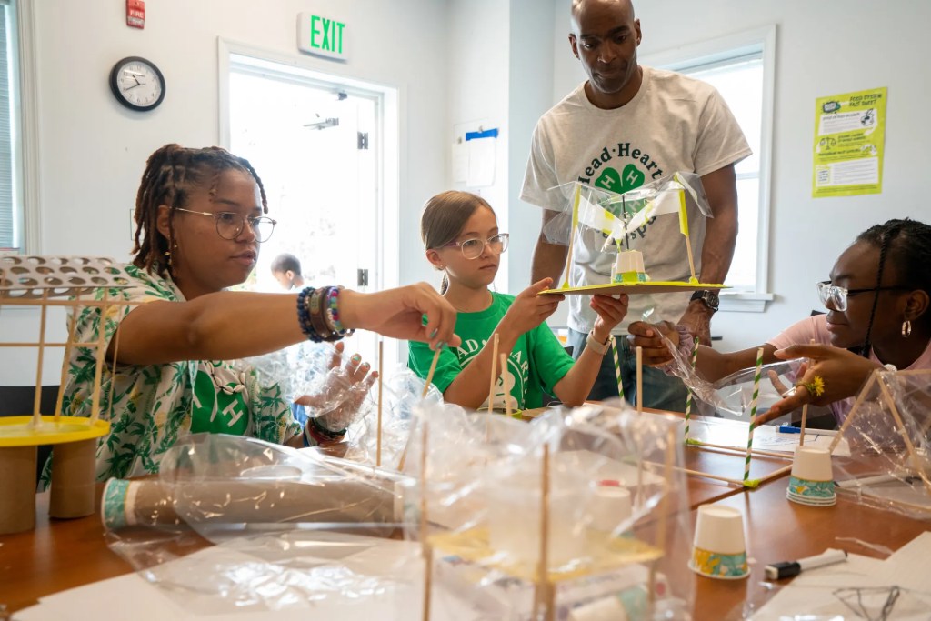 Youth participating in a 4-H project with an adult volunteer