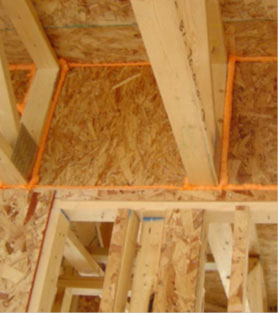 Figure 3. Joists running through a common wall of a garage can be sealed with caulk, spray foam, or water-based elastomeric sealant if exposed.