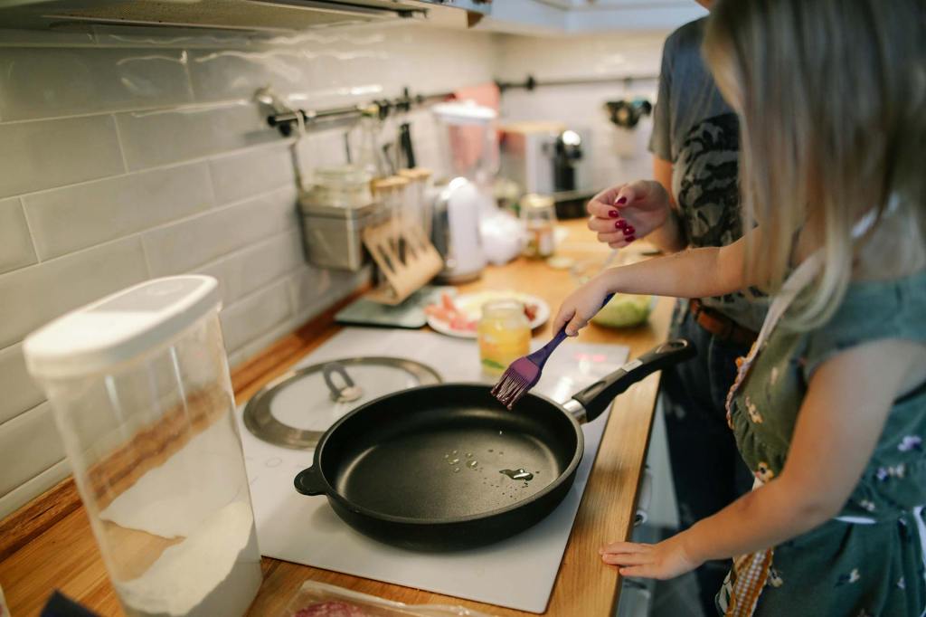 A mother and daughter cook a meal together at home