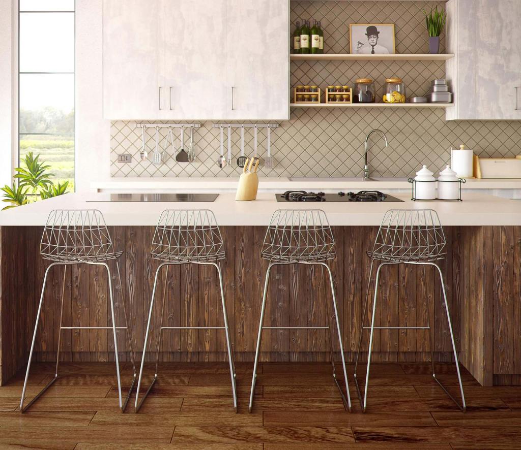 A kitchen with stools in front of a counter