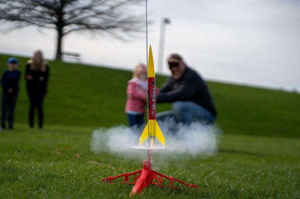A model rocket being launched outdoors