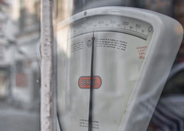 A scale for weighing objects as seen through a glass shop window