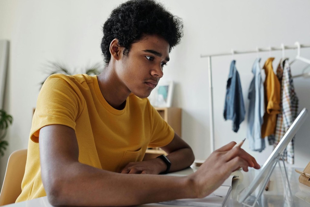 A young man works on his tablet