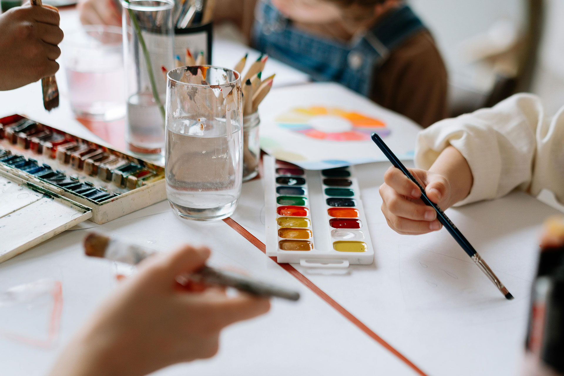 A group of kids work on a painting project