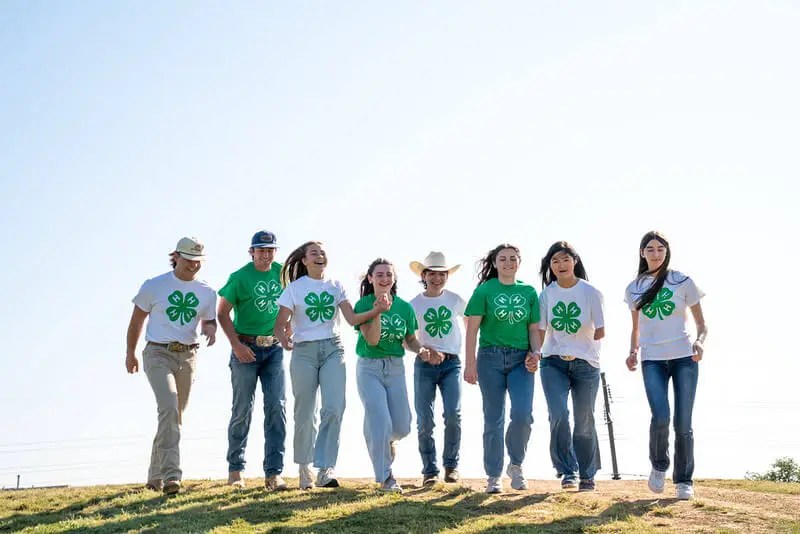 A group of 4-H youth members walk together outside