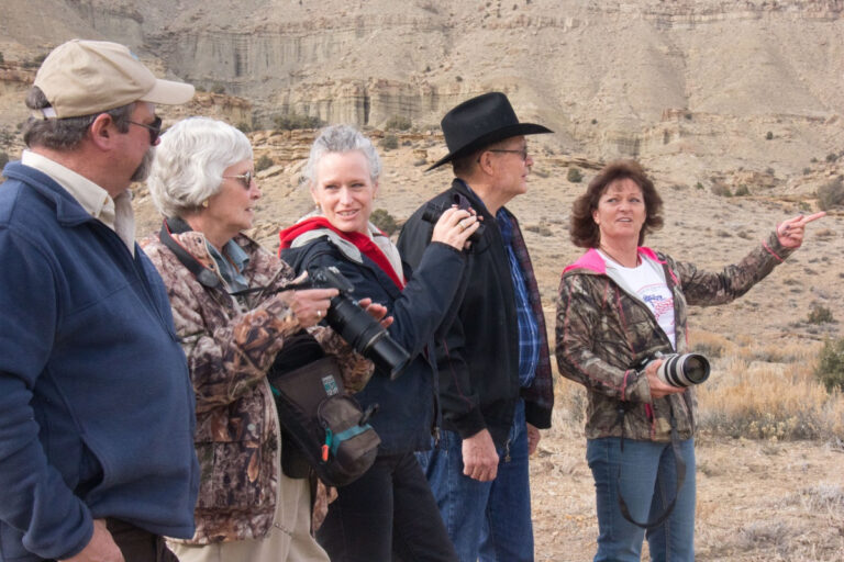 BLM Photo: BLM Colorado State Director Ruth Welch (center) joins members of the Little Book Cliffs Darting Team to view horses at the Little Book Cliffs.