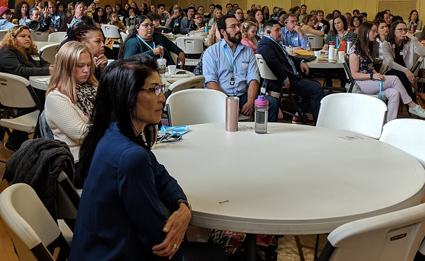 A large group of people attend a seminar