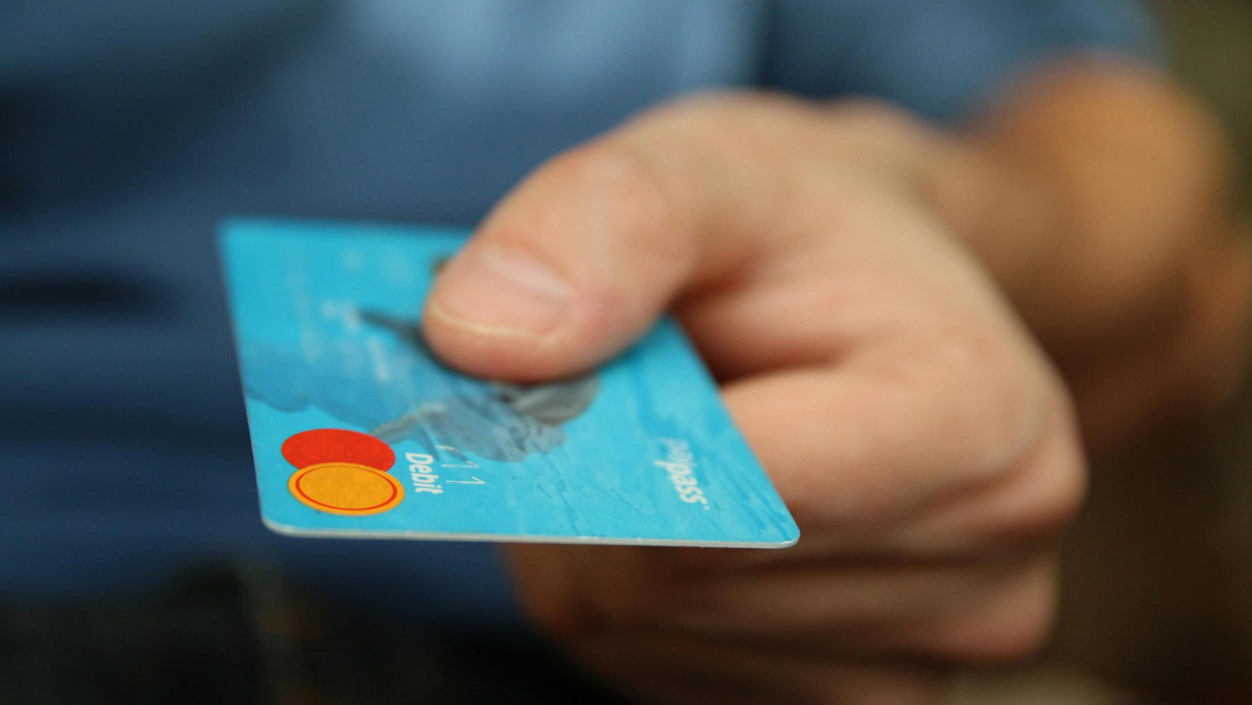 Close-up view of a hand holding a credit card