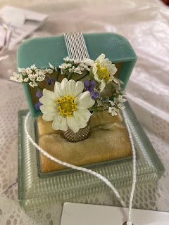 Open ring box holding a ring with flowers emerging from it (Flowers for Mom). Open Class Horticulture Entries at the Yuma County Fair 2023.