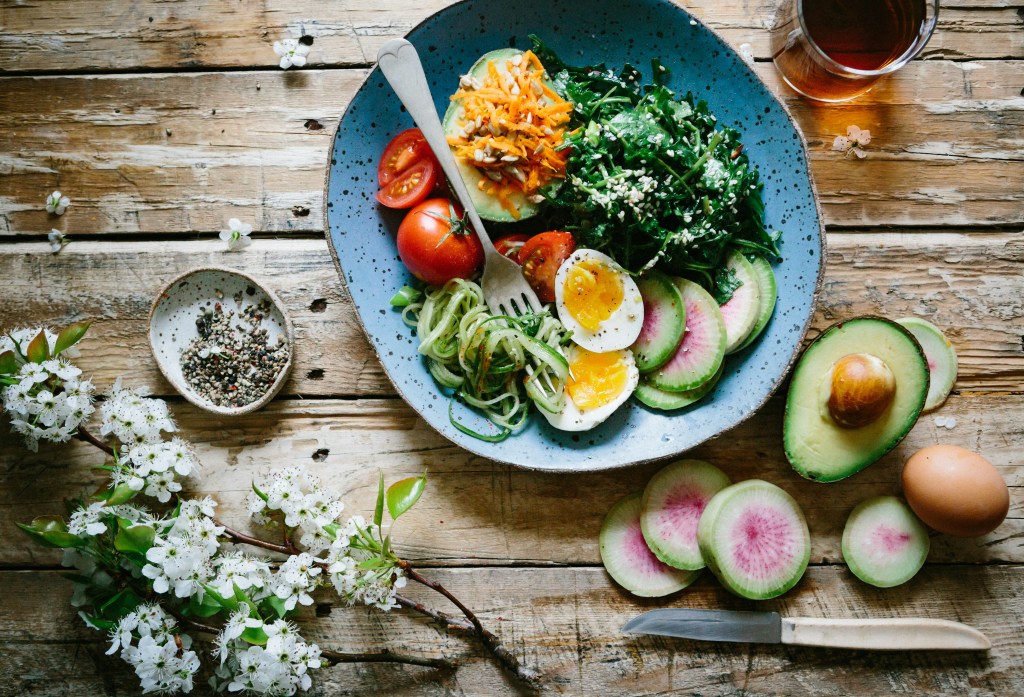 A meal with fresh vegetables, soft-boiled eggs, and avocado, offering a delicious blend of flavor, texture, and nutrition.