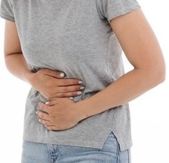 Adult holding their stomach in pain.