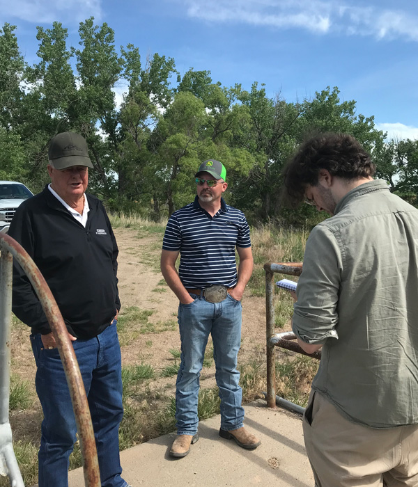 Tobin Gold, History major student, interviewing two employees from the Sterling Irrigation Company.