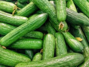 a pile of green cucumbers