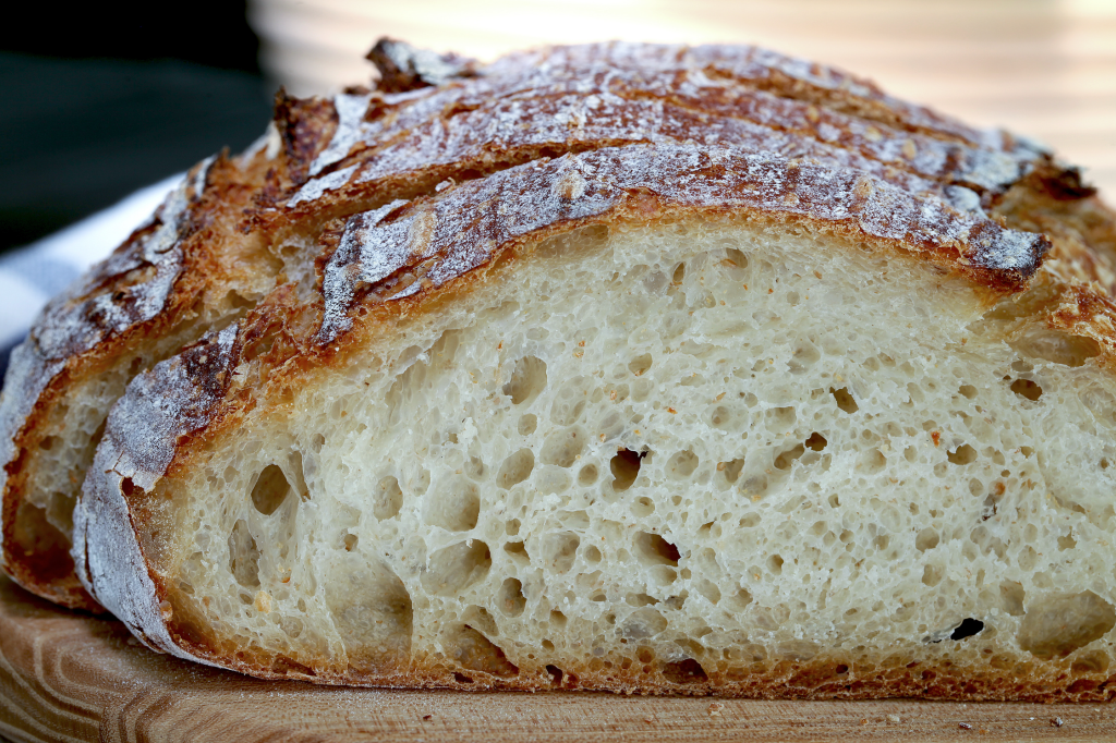 A close view of a slice of baked sourdough bread