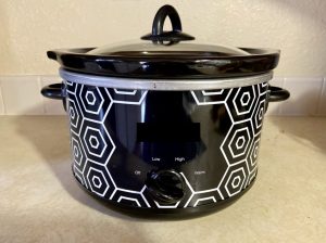A black and silver crockpot on a counter