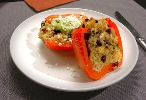 Quinoa Stuffed Bell Peppers with Basil Sauce on a white plate