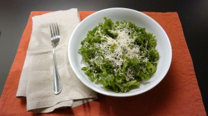 Massaged kale salad topped with shredded parmesan.