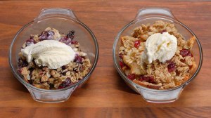 Two individual fruit crisps, including a blueberry crisp and an apple/cranberry crisp.