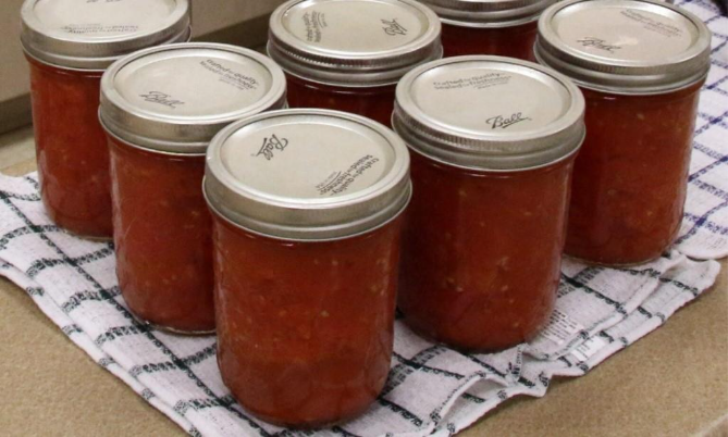 Sealed jars of canned tomatoes