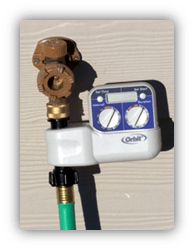 Picture of a single zone controllers connect to the hose line.
Right: This battery-powered controller turns water on and off at the day and time intervals set by the gardener.