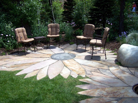A flower shaped patio with chairs and firepit is designed for group conversation.
