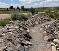 A crevice garden built from rocks and soil stabilizes the slope.