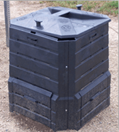 A photograph of a black compost bin made of plastic. It is square in footprint and about three feet tall, and has a lid.