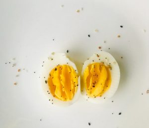 a hard-cooked egg peeled and sliced with spices on top