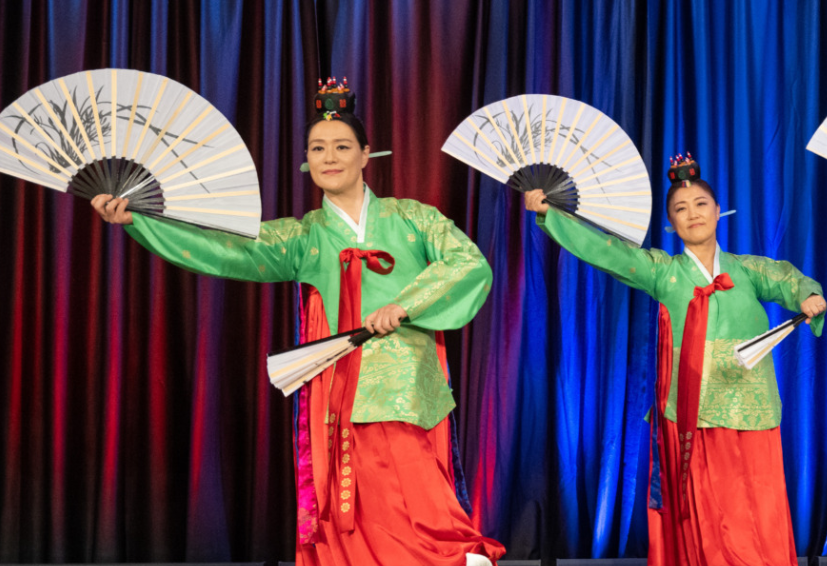 Women perform a traditional dance with fans