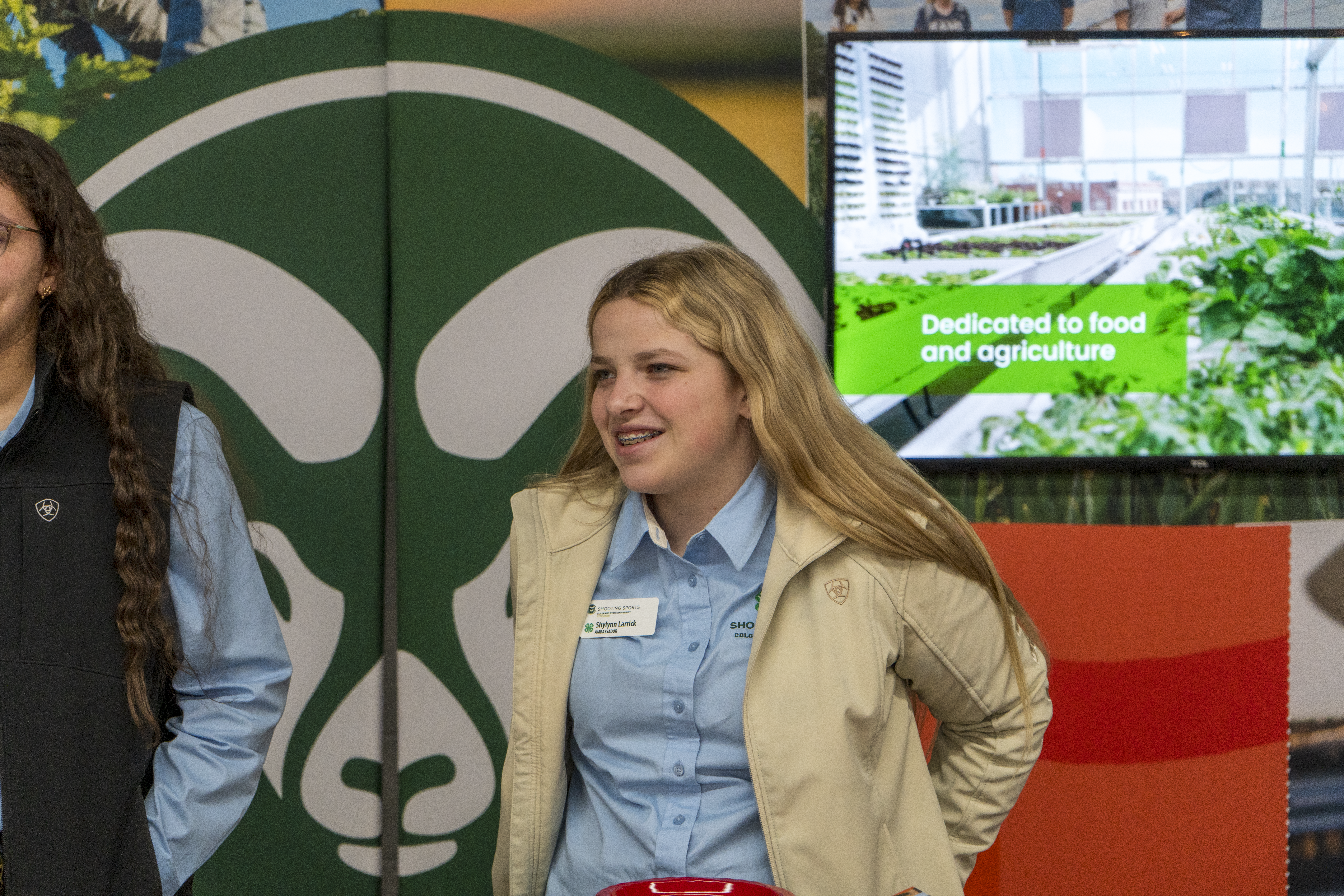 Morgan County 4-H'er Shylynn Larrick pictured in front of a CSU Rams backdrop at the National Western Stock Show during 4-H day.